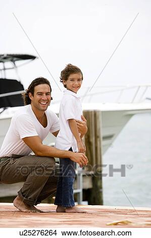 father and son on dock in marina View Large Photo Image Picture - father and son on dock in marina. Fotosearch