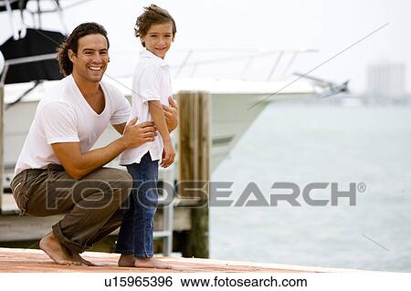 father and son on dock in marina View Large Photo Image Stock Photograph - father and son on dock in marina. Fotosearch