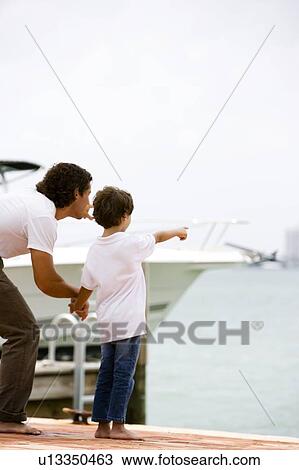 father and son pointing at sea from dock View Large Photo Image Stock Image - father and son pointing at sea from dock. Fotosearch