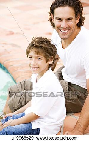 father and son sitting on edge of swimming pool View Large Photo Image Stock Photo - father and son sitting on edge of swimming pool. Fotosearch