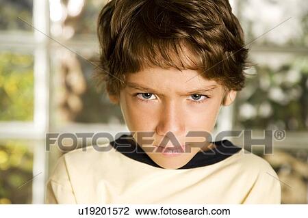 Stock Image - Latino boy frowning. Fotosearch