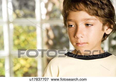 Stock Photo - Latino boy looking sad. Fotosearch