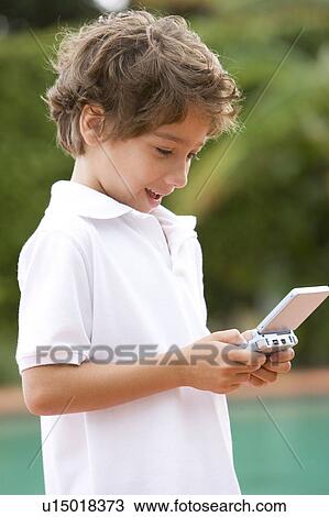 little boy playing with hand held computer game View Large Photo Image Stock Image - little boy playing with hand held computer game. Fotosearch