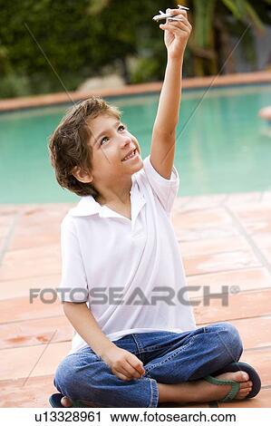little boy playing with toy aeroplane on terrace View Large Photo Image Stock Image - little boy playing with toy aeroplane on terrace. Fotosearch