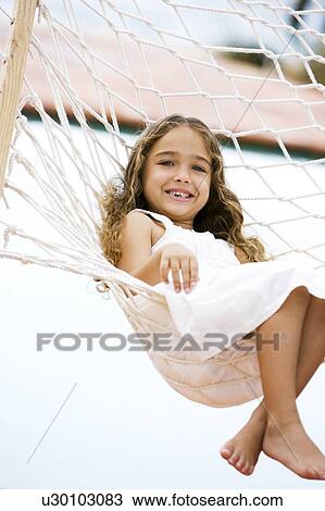 little girl sitting in a hammock View Large Photo Image Stock Image - little girl sitting in a hammock. Fotosearch