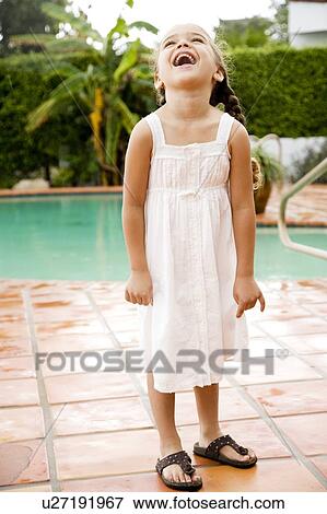 little Hispanic girl laughing standing by pool View Large Photo Image Stock Photo - little Hispanic girl laughing standing by pool. Fotosearch