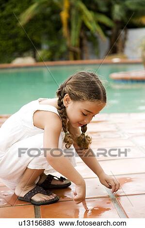 little Hispanic girl playing by the pool View Large Photo Image Stock Image - little Hispanic girl playing by the pool. Fotosearch
