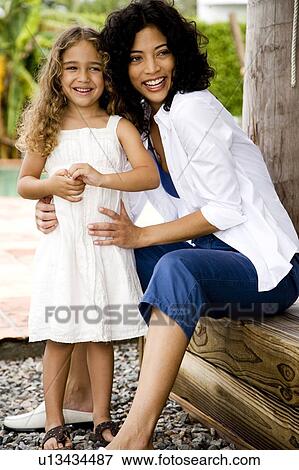 mother and daughter looking at something amusing View Large Photo Image Stock Photo - mother and daughter looking at something amusing. Fotosearch
