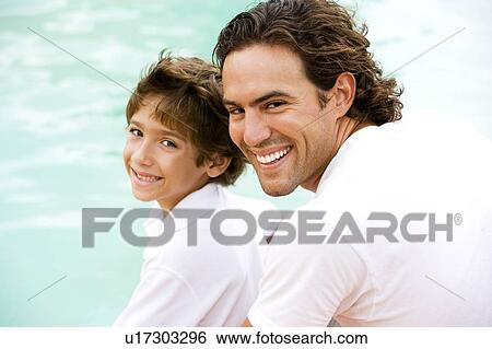 Stock Photograph - portrait of father and son by water. Fotosearch
