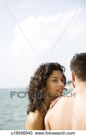 Close-up of romantic couple sitting by the sea View Large Photo Image Stock Image - Close-up of romantic couple sitting by the sea. Fotosearch