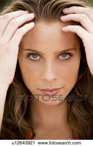 Stock Image - Close-up portrait of woman with long brown hair. Fotosearch