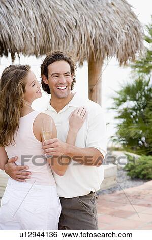 Couple at a tropical hotel bar, drinking champagne View Large Photo Image Stock Photograph - Couple at a tropical hotel bar, drinking champagne. Fotosearch