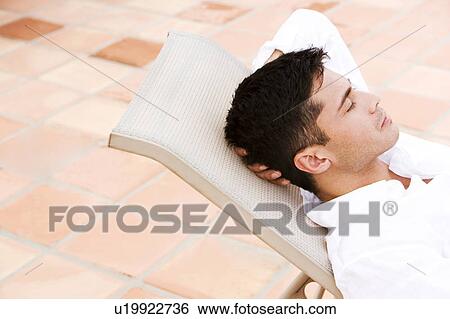 Man relaxing by the pool View Large Photo Image Stock Photograph - Man relaxing by the pool. Fotosearch