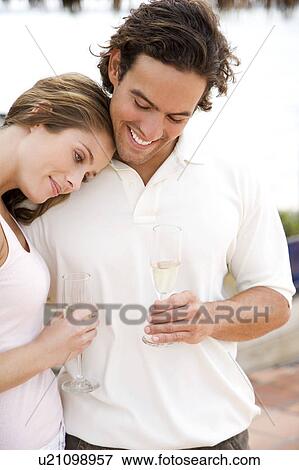 Romantic couple at a tropical hotel bar, drinking champagne View Large Photo Image Stock Photo - Romantic couple at a tropical hotel bar, drinking champagne. Fotosearch