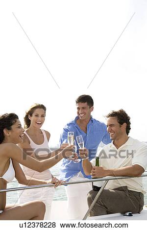 Two couples having drinks on board a luxury yacht View Large Photo Image Stock Photo - Two couples having drinks on board a luxury yacht. Fotosearch