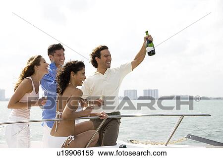 Two couples having drinks on board a luxury yacht View Large Photo Image Stock Photo - Two couples having drinks on board a luxury yacht. Fotosearch
