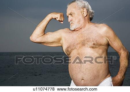 Portrait of a senior man flexing his biceps View Large Photo Image Stock Photo - Portrait of a senior man flexing his biceps . Fotosearch