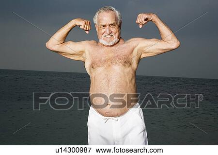 Stock Photo - Portrait of a senior man flexing his biceps . Fotosearch