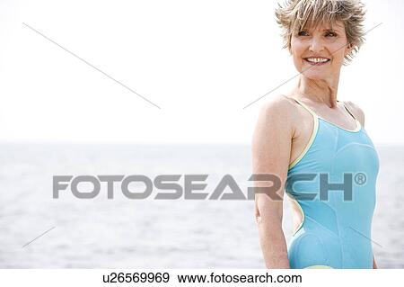 Portrait of a smiling senior woman in a swimsuit at the beach View Large Photo Image Stock Photo - Portrait of a smiling senior woman in a swimsuit at the beach . Fotosearch