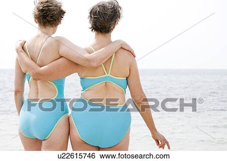Portrait of a two senior women arm in arm at the beach View Large Photo Image Stock Photograph - Portrait of a two senior women arm in arm at the beach. Fotosearch