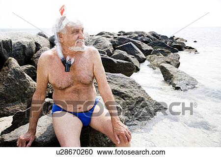 Senior man with snorkel gear at the beach View Large Photo Image Stock Image - Senior man with snorkel gear at the beach . Fotosearch