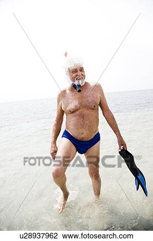 Senior man with snorkel gear at the beach View Large Photo Image Stock Image - Senior man with snorkel gear at the beach . Fotosearch