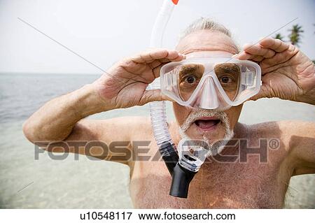 Senior man with snorkel gear at the beach View Large Photo Image Stock Photo - Senior man with snorkel gear at the beach . Fotosearch