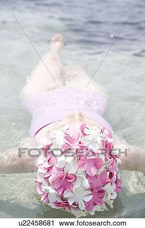 Senior woman in a swimming hat, floating in the ocean View Large Photo Image Stock Image - Senior woman in a swimming hat, floating in the ocean . Fotosearch