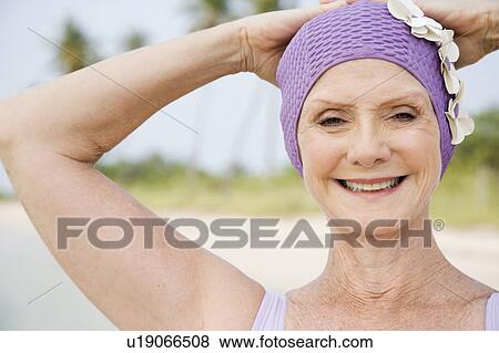 Senior woman in a swimsuit and swimming hat. View Large Photo Image Stock Photo - Senior woman in a swimsuit and swimming hat.. Fotosearch