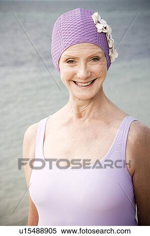 Senior woman in a swimsuit and swimming hat, at the beach View Large Photo Image Stock Photography - Senior woman in a swimsuit and swimming hat, at the beach . Fotosearch