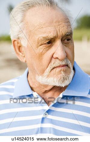 Portrait of a senior man standing on a beach View Large Photo Image Stock Photography - Portrait of a senior man standing on a beach . Fotosearch