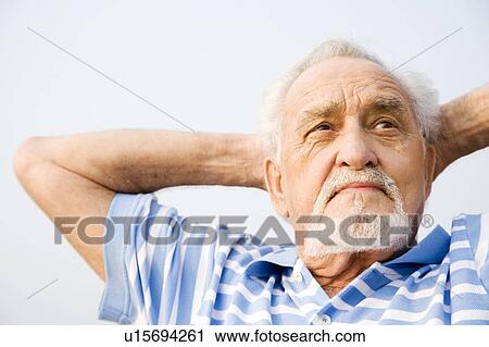 Portrait of a senior man with his hands behind his head View Large Photo Image Stock Image - Portrait of a senior man with his hands behind his head. Fotosearch
