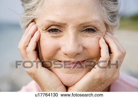 Stock Image - Portrait of a senior woman at the beach . Fotosearch