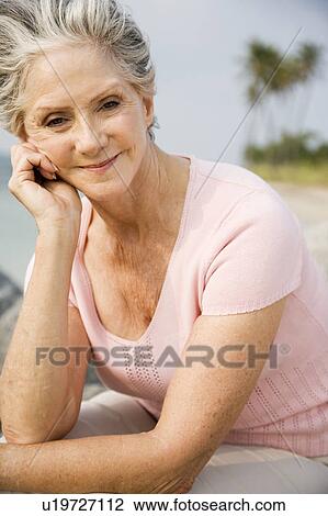 Portrait of a senior woman at the beach View Large Photo Image Stock Image - Portrait of a senior woman at the beach . Fotosearch