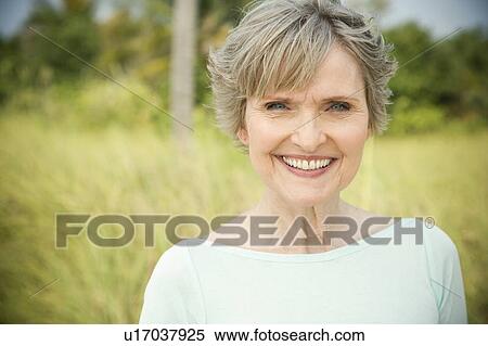 Portrait of a smiling senior woman in a tropical dune setting View Large Photo Image Stock Photography - Portrait of a smiling senior woman in a tropical dune setting . Fotosearch