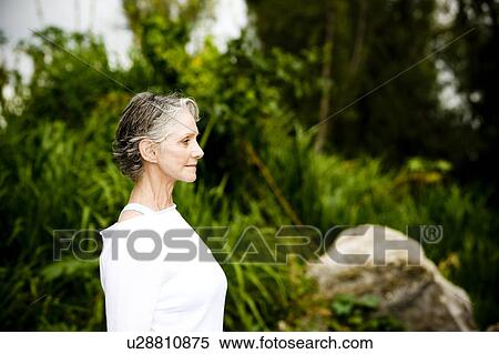 Portrait of a smiling senior woman in front of tropical foliage View Large Photo Image Stock Photography - Portrait of a smiling senior woman in front of tropical foliage . Fotosearch