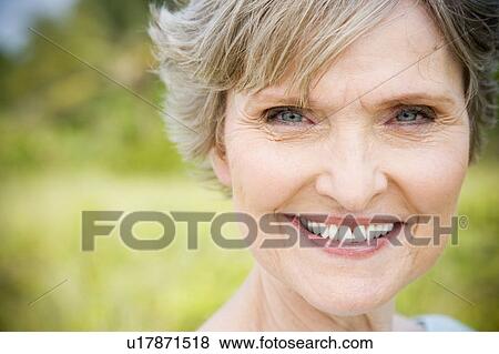 Portrait of a smiling senior woman View Large Photo Image Stock Photo - Portrait of a smiling senior woman . Fotosearch
