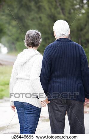 Stock Photography - Senior couple walking hand in hand . Fotosearch
