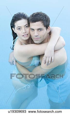 A couple embracing in a pool View Large Photo Image Stock Image - A couple embracing in a pool. Fotosearch
