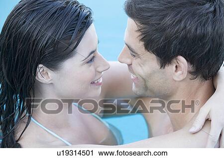 A couple embracing in a pool View Large Photo Image Stock Image - A couple embracing in a pool. Fotosearch
