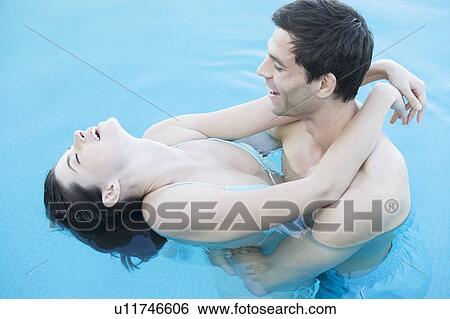 A couple embracing in a pool View Large Photo Image Stock Photograph - A couple embracing in a pool. Fotosearch