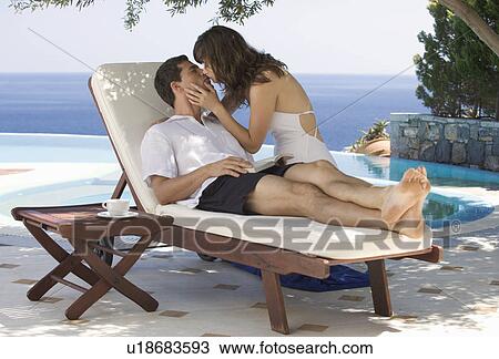 A couple kissing by a pool View Large Photo Image Stock Image - A couple kissing by a pool. Fotosearch