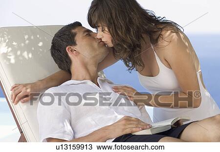 A couple kissing on holiday View Large Photo Image Stock Image - A couple kissing on holiday. Fotosearch