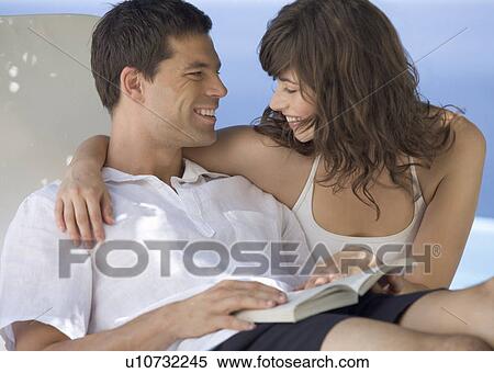 A couple relaxing by a pool View Large Photo Image Stock Photography - A couple relaxing by a pool. Fotosearch