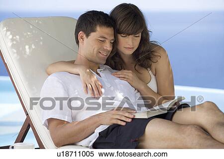 A couple relaxing by a pool View Large Photo Image Stock Photography - A couple relaxing by a pool. Fotosearch