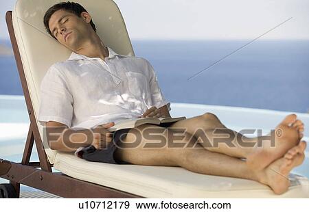Stock Photo - A man relaxing by a pool. Fotosearch