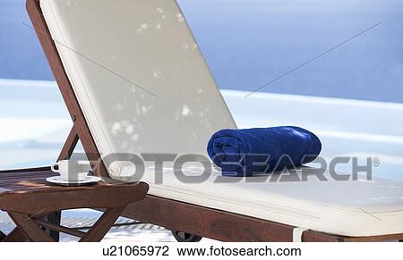 Stock Image - A sun lounger by a pool. Fotosearch