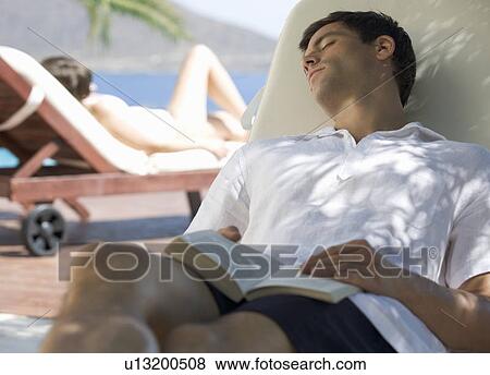 Two people relaxing in the sun View Large Photo Image Stock Photo - Two people relaxing in the sun. Fotosearch
