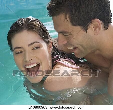 A couple embracing in a pool View Large Photo Image Stock Image - A couple embracing in a pool. Fotosearch
