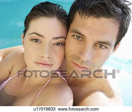 A couple embracing in a pool View Large Photo Image Stock Image - A couple embracing in a pool. Fotosearch